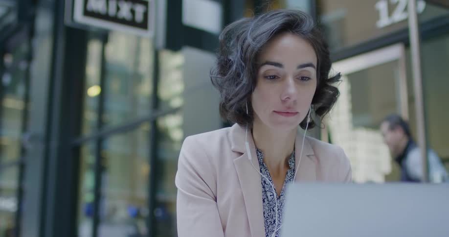 A woman sitting on a laptop