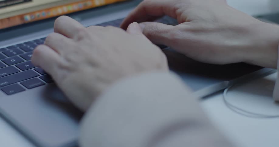 A woman typing on a laptop