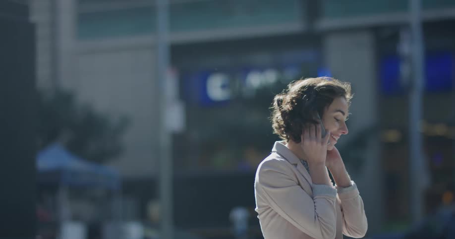 A woman talking on a cell phone outdoors in the city