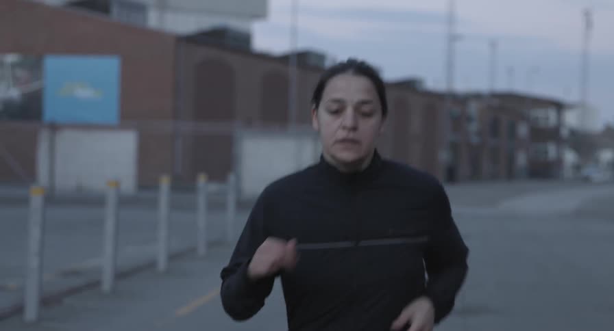 A woman runs along the road