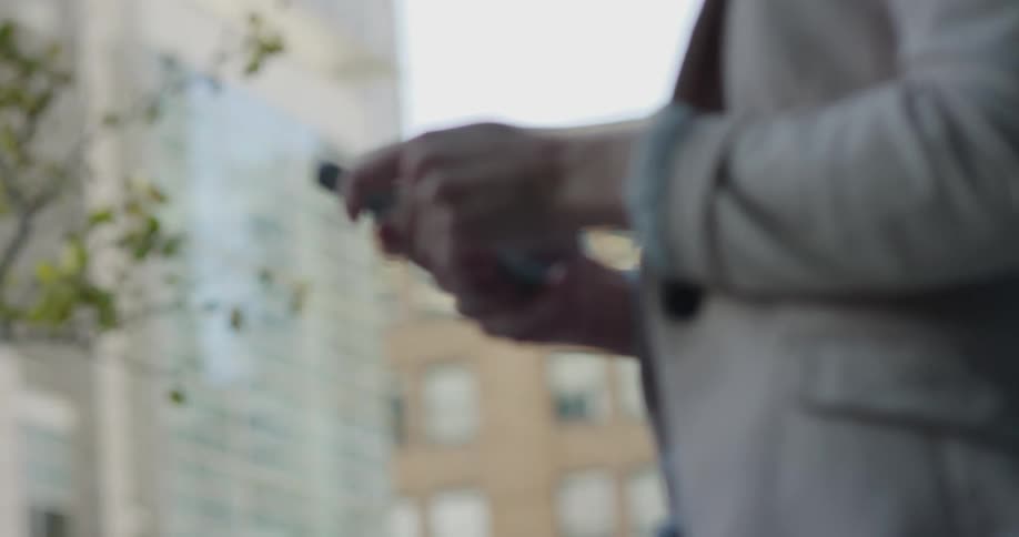 A woman is using her phone outside