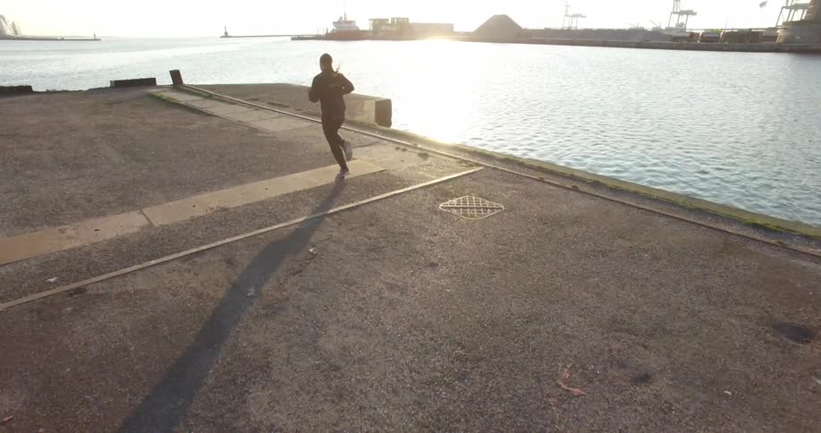 Woman jogs along a pier
