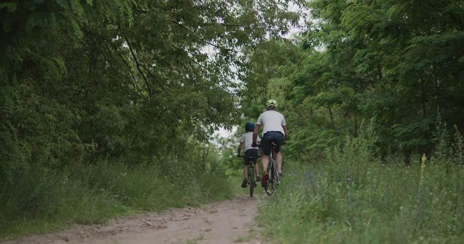 Two people ride their bicycles on the trail together