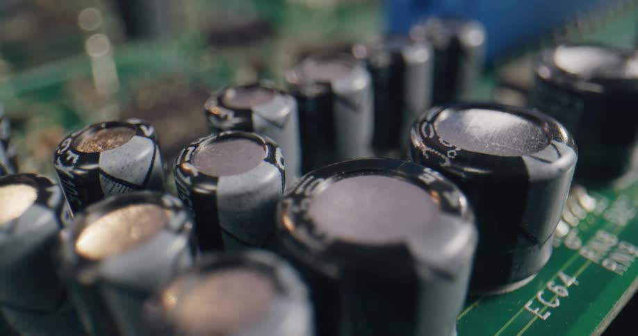 A close up of capacitors and resistors on a motherboard