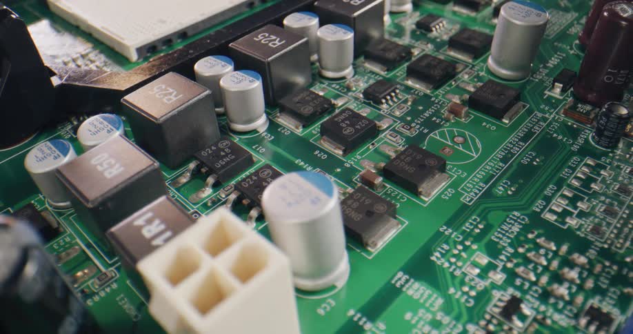 A green circuit piece with raised black silver and white components