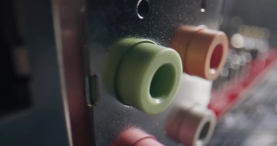 Close up of the colorful audio ports on the back of a red computer audio card