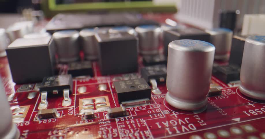 Electronic components on the surface of a red computer audio card