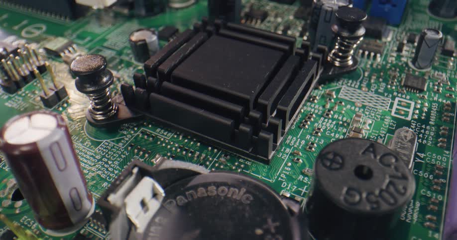 Close up of the components of a green motherboard