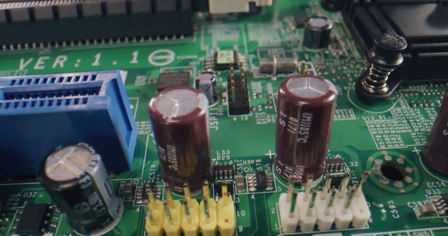 A close up of a green board with plastic and metal components