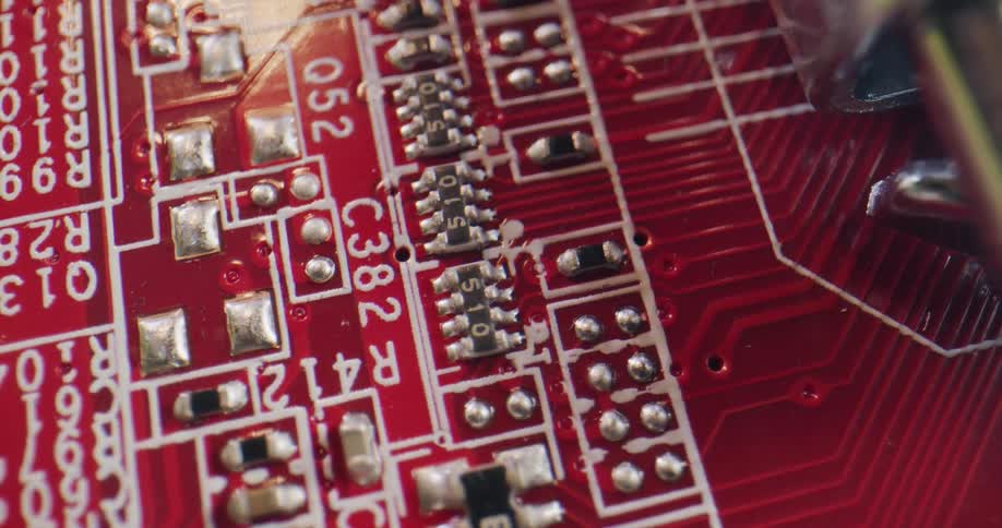 Extreme close up of the components on a red motherboard