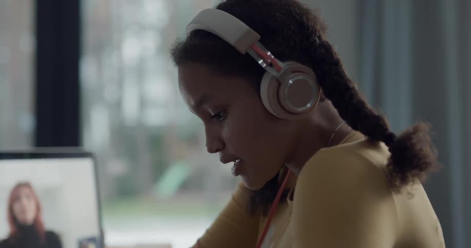 A teenager talking to an older woman in a video call