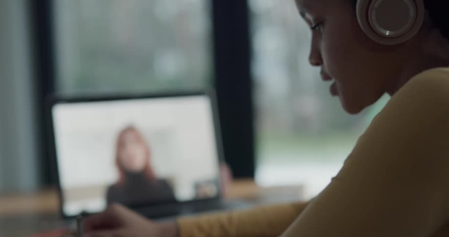 A child is talking with a teacher with online learning