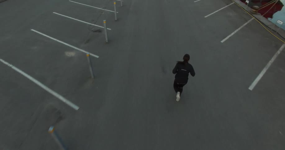 A woman jogs down a pier