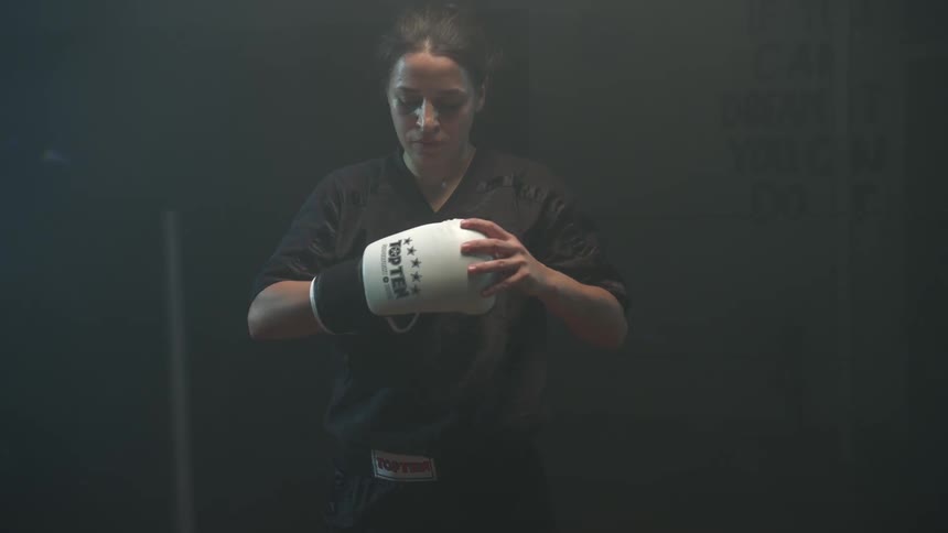 Woman removing boxing gloves