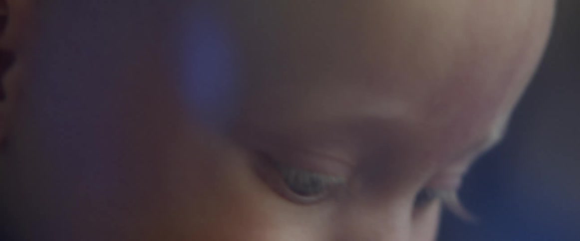 Close up of a babys face looking around