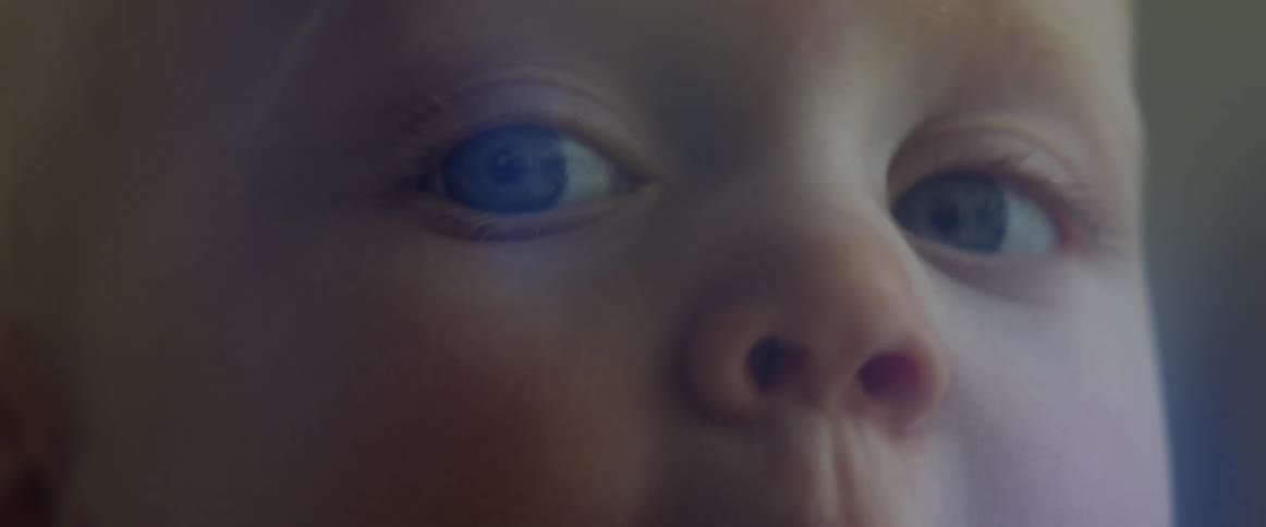 Close up of a babys face looking around