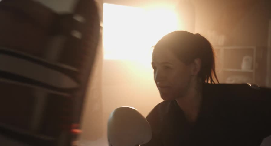 A woman practices punching someone