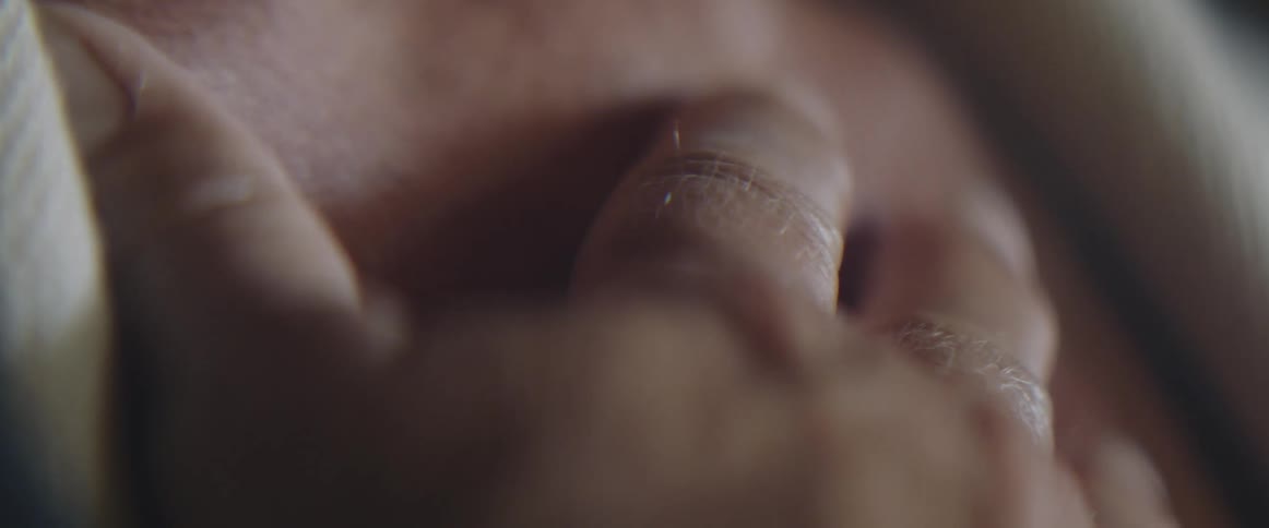 Close up of a woman with her hand placed over her chest