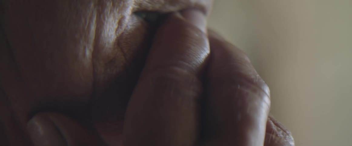 Close up of an elderly womans face crying as the result of a strong emotion