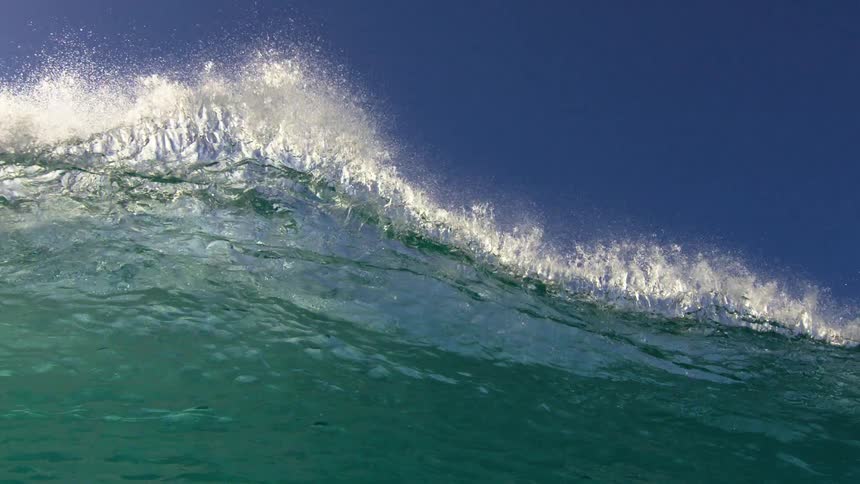In water footage of large wave breaks against the shore