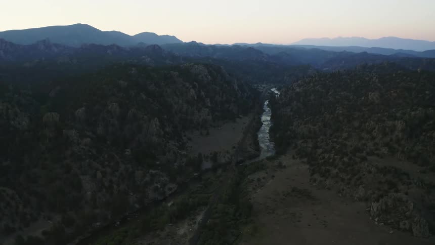 Canyon river valley fjord with mountains on the horizon on a hazy day