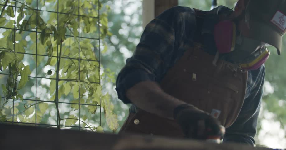A man using power tools on a piece of wood