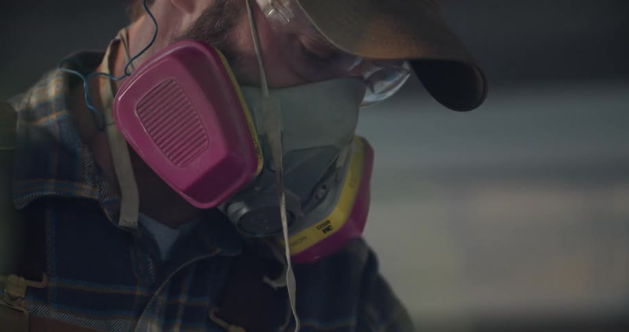 A man with a shirt a hat a goggles and a mask