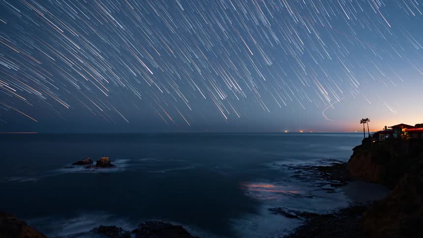 Time lapse of stars over the water and coast