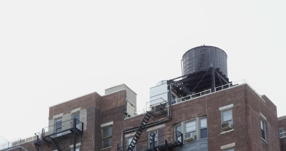 A camera panning down to show a tall building