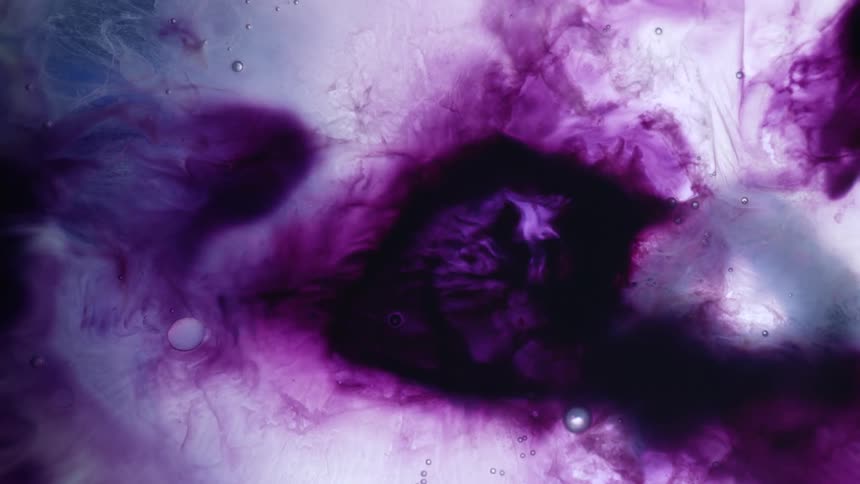 Different hues of purple liquid flowing together