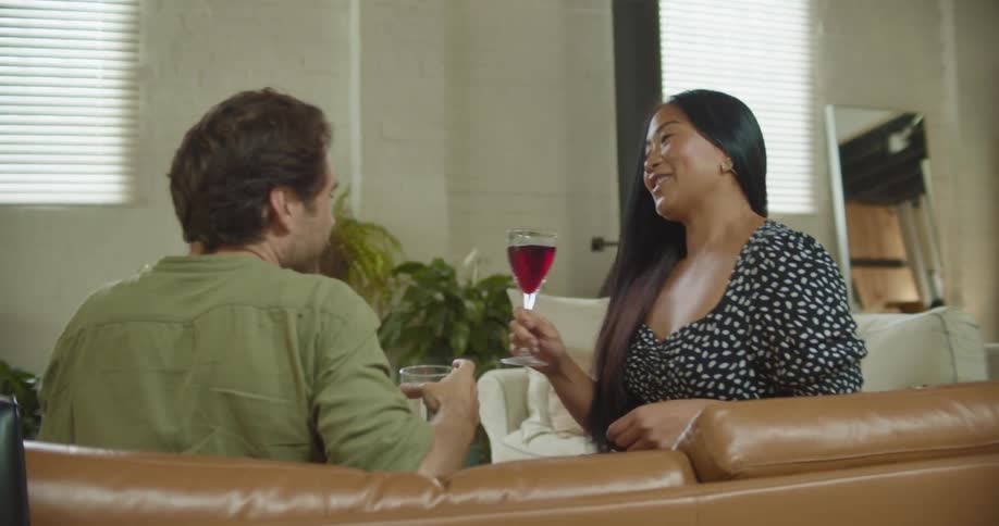 Young cople drink alcoholic beverarges on a date at home