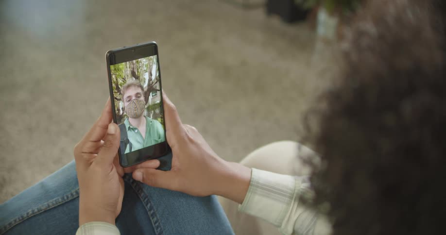 A woman talking to a man via video call