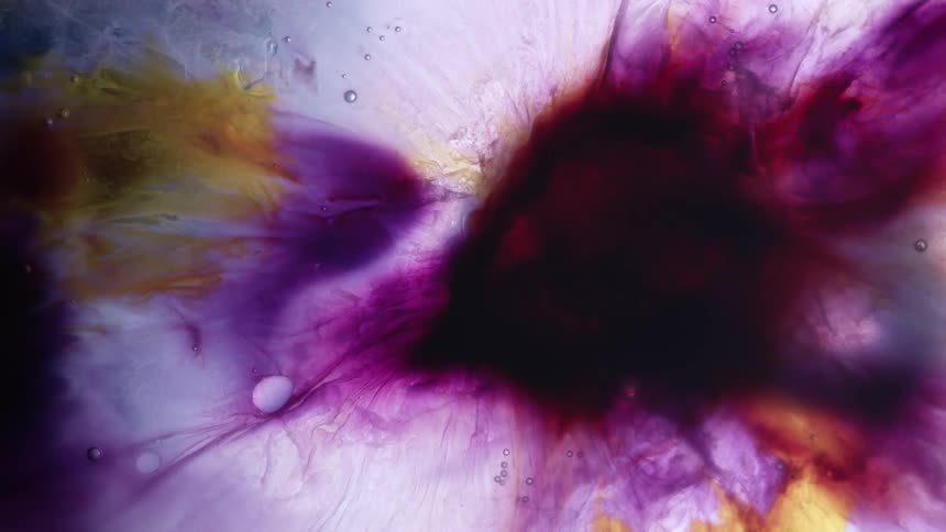 A mix of colorful liquids swirls and blends in abstract and unusual ways
