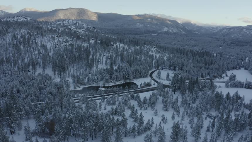 Winter landscape of mountains and trees with winding road