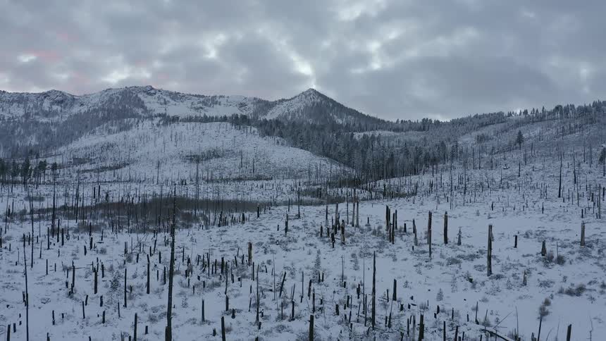 Snow covered mountains and ground on a cloudy winter day