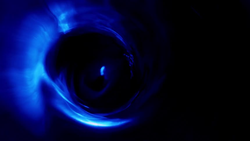 Electric blue whirlpool spins against dark background