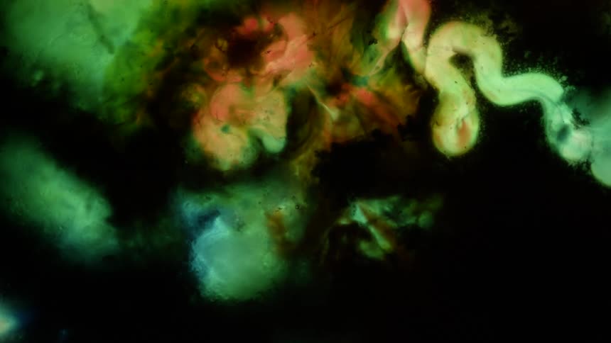 Colorful psichedelic pattern green and yellow ink over black