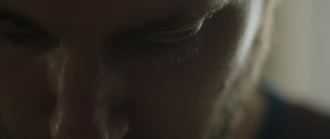 The face of a man looking downwards
