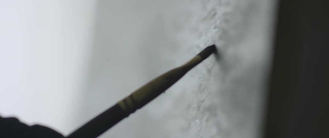 Someone painting on a canvas