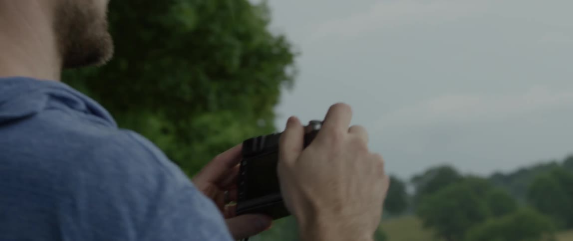 Man takes a photograph in a rural area