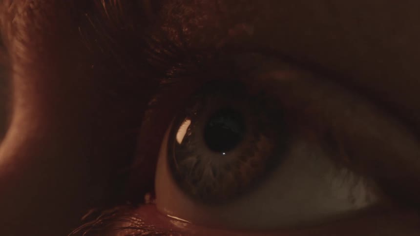 A person is looking around in the dark