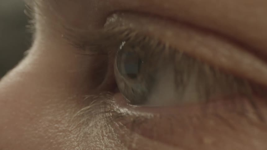 A close up of an eye with eyelid and eye lashes