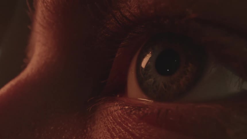 A close up of a blue eye and eyelashes on a face