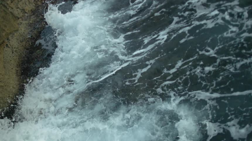 Ocean waves splashing and rolling in onto coast