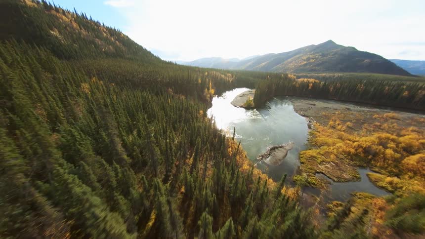 An aerial view of mountains river and trees