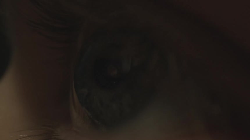 Close up of a light flashing on a persons eye