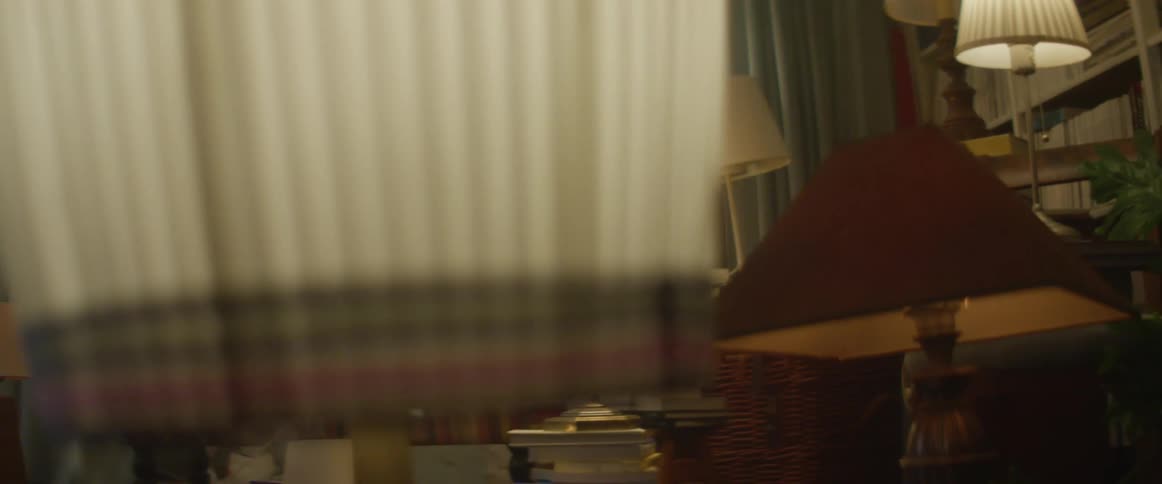 Group of table lamps turned on inside a dimly lit livingroom at night