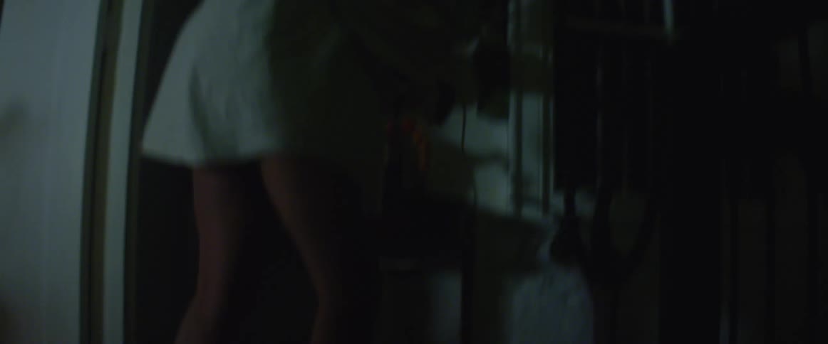 A man unplugs a lamp at home and quickly walks away with it