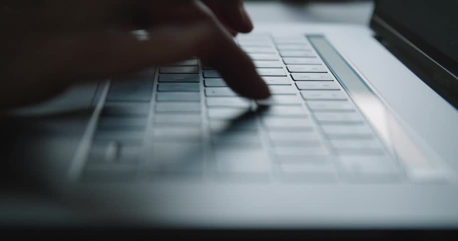 A person typing on a laptop