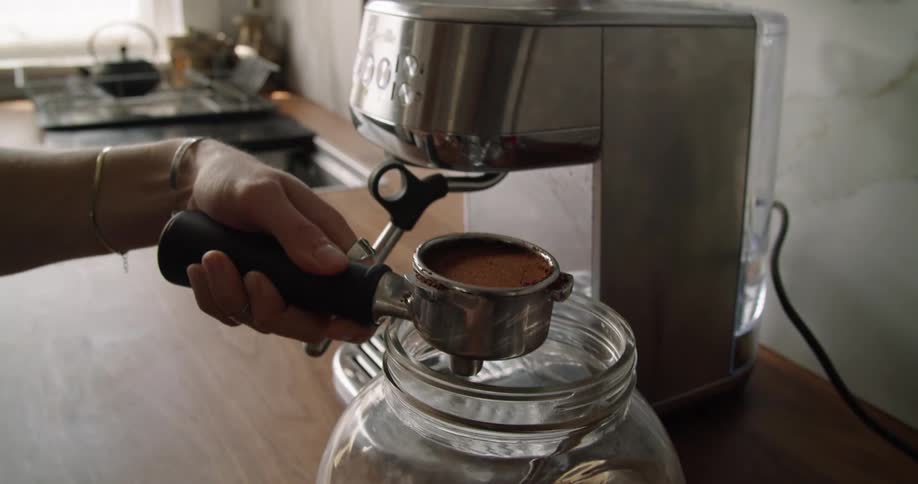 A woman making coffee at home